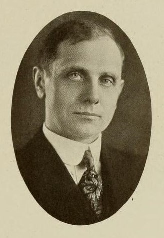 Black and white photograph of a man in a suit and tie
