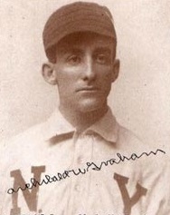 Black and white photograph of man in baseball uniform.