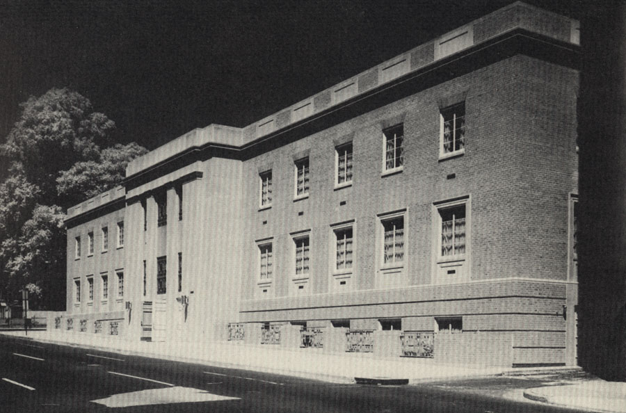 Black and white photograph of a three story brick building.