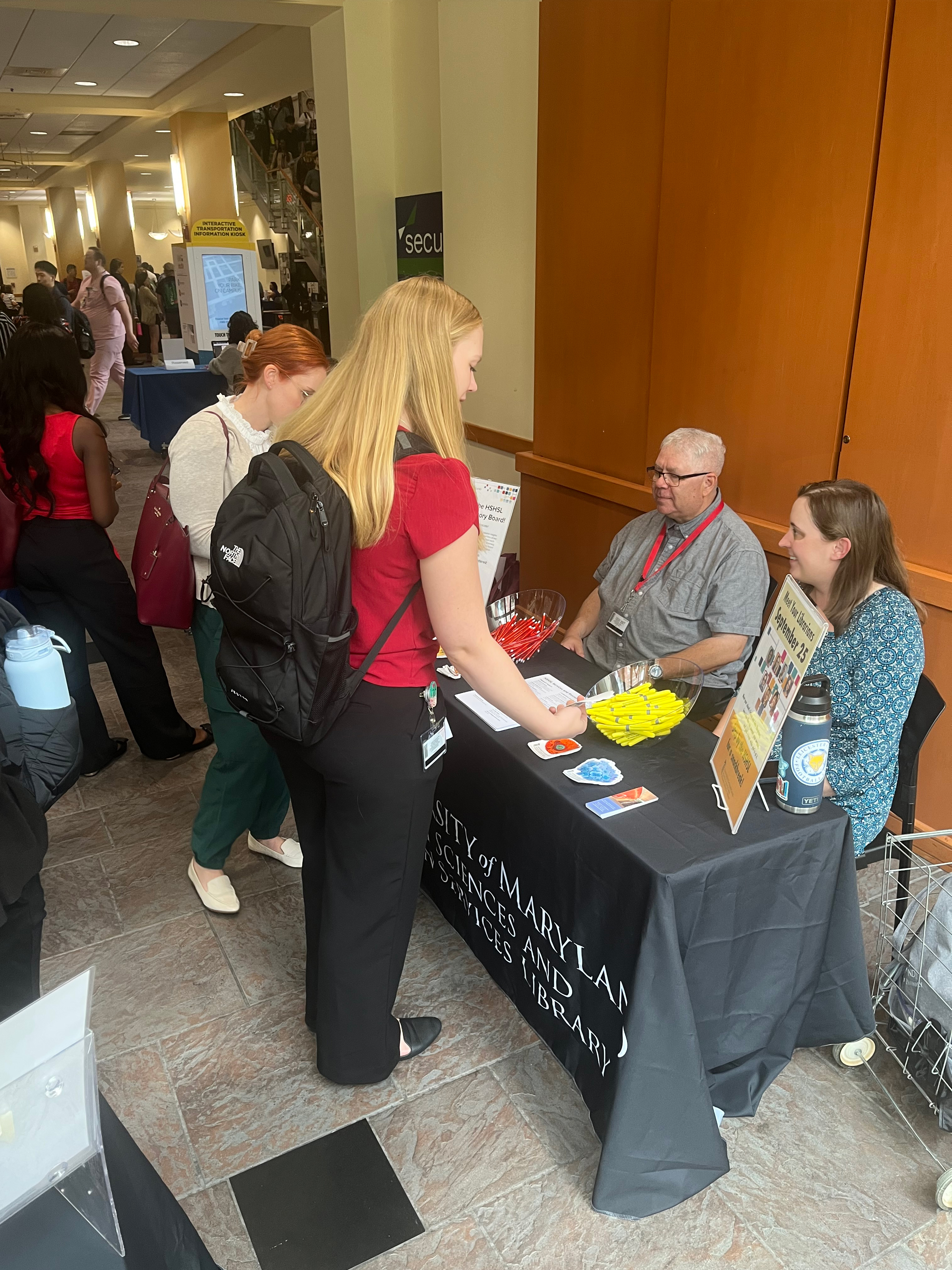 Ivan Freedman and Emily Gorman at the HSHSL's table at a student event.