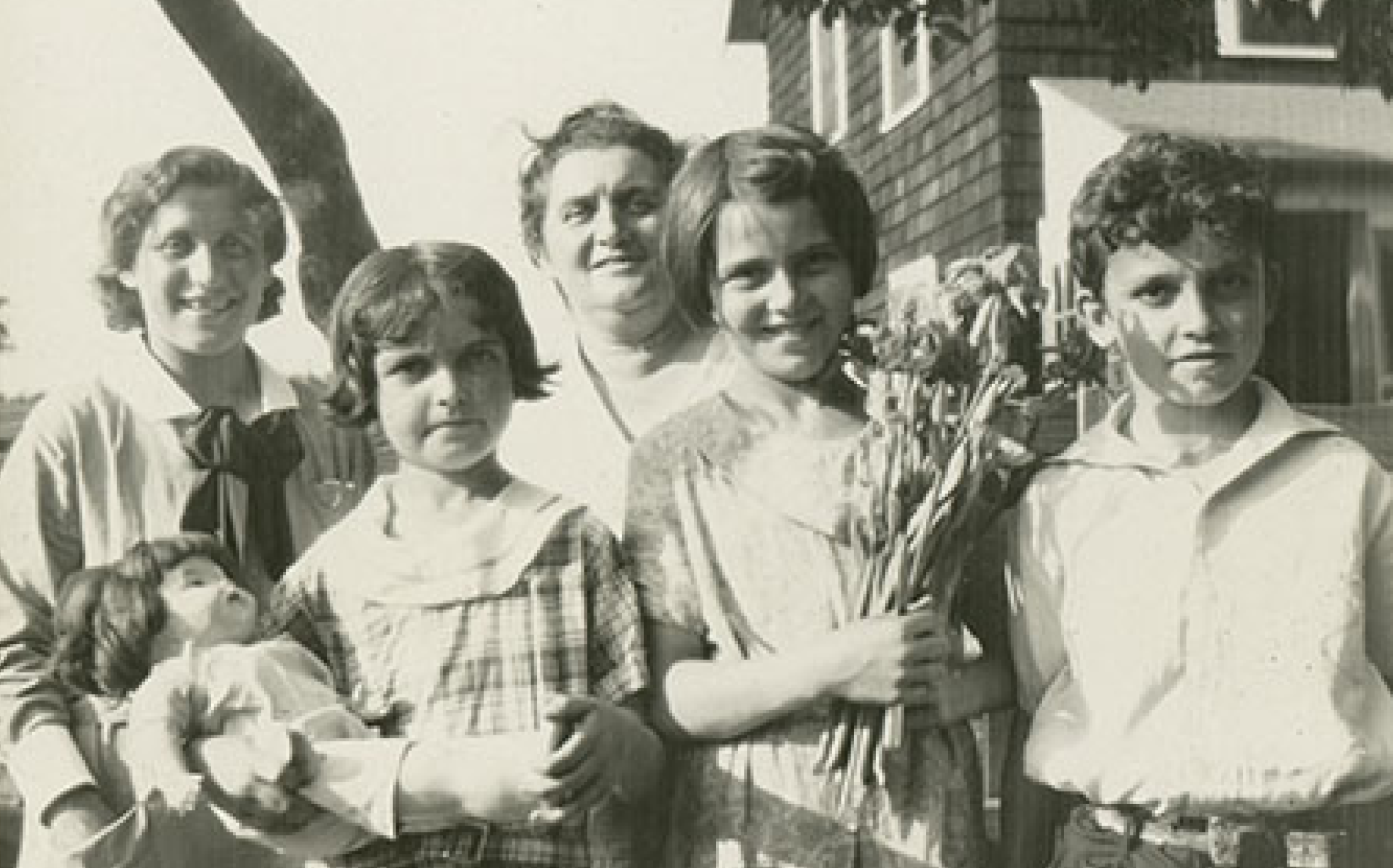 Black and white snapshot of a large immigrant family, provided by the National Library of Medicine to compliment their traveling exhibit, Outside/Inside.
